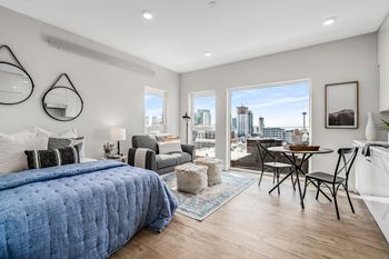 a bedroom with a large bed and a view of the city  at Oslo, Seattle, 98102